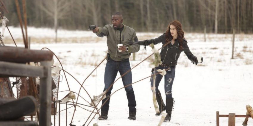 WYNONNA EARP -- "Constant Cravings" Episode 106 -- Pictured: (l-r) Shamier Anderson as Agent Dolls, Melanie Scrofano as Wynonna Earp -- (Photo by: Michelle Faye/Syfy/Wynonna Earp Productions)