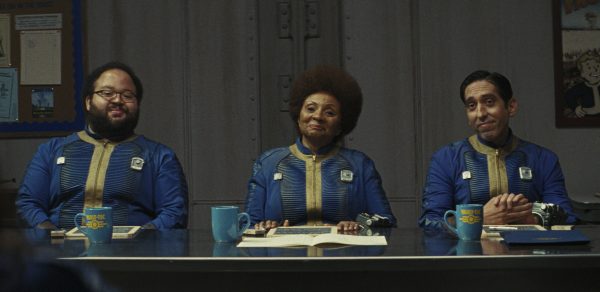 Three Vault dwellers sit at a table smiling